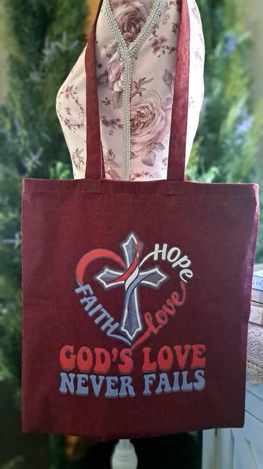 Burgundy God's Love Never Fails Tote bag